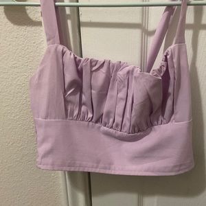The color is a light purple with ruffles on the top and has a  stretchy back.